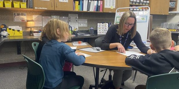 Heather Coy plays a reading game with students at Greensferry Elementary