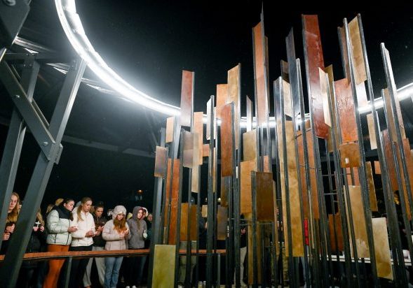 Students gather Wednesday in front of the sculpture dedicated to the four University of Idaho students murdered in Moscow in 2022, at a vigil marking the two-year anniversary of the slayings. Liesbeth Powers/Moscow-Pullman Daily News